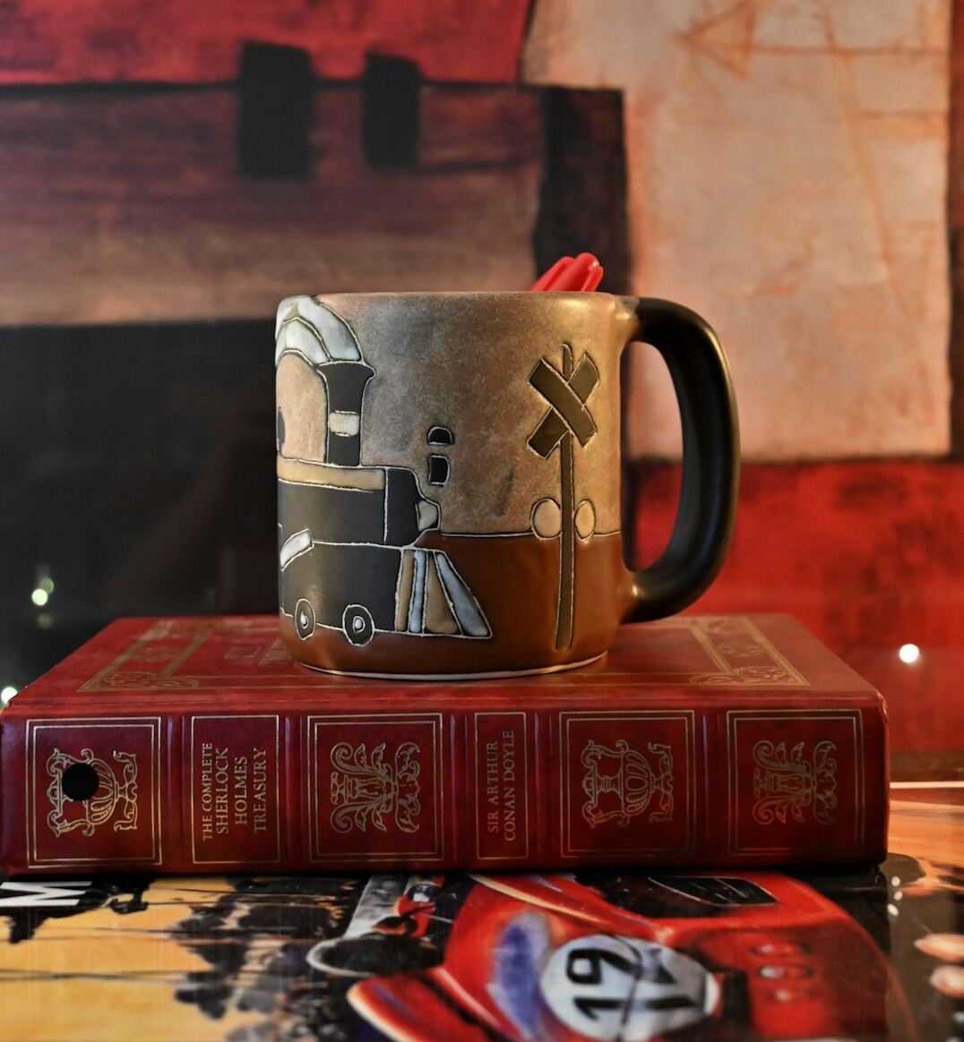 Books and a cup on a desk
