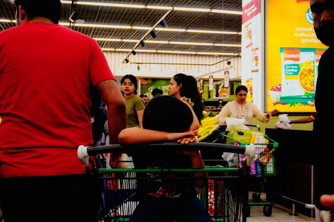man hiding items in supermarket
