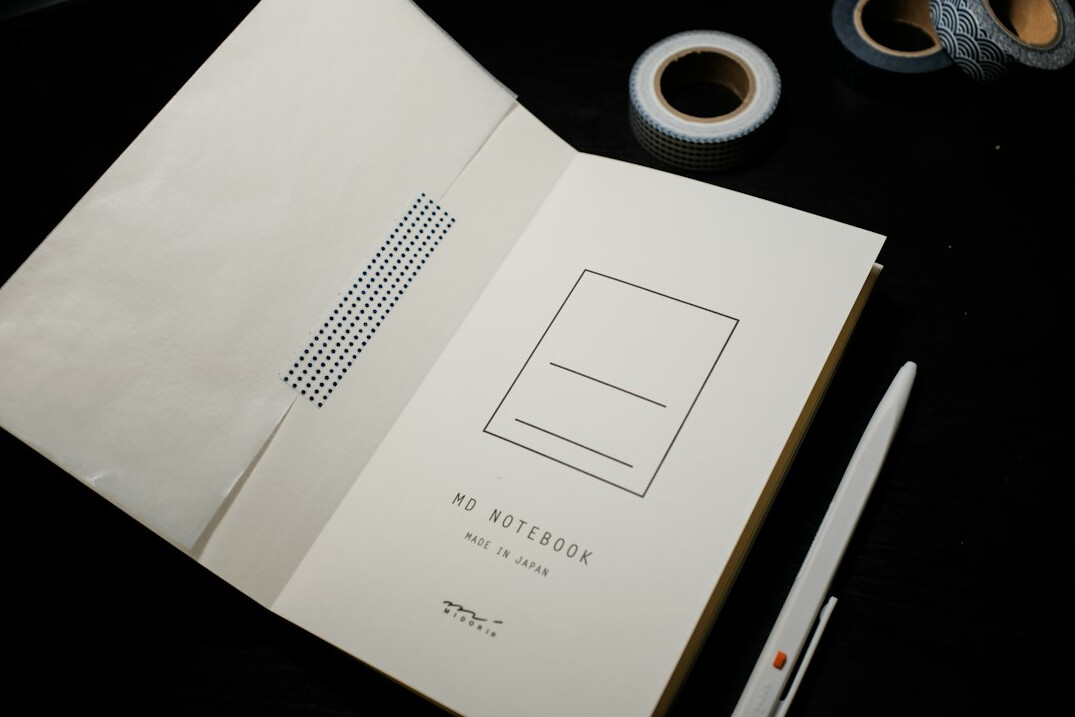 Notebook and pen on a wooden desk